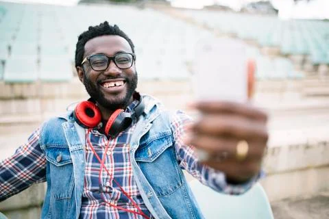 American man using mobile in the street. Stock Photos