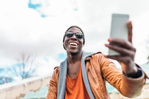 American man using mobile in the street. Stock Photos