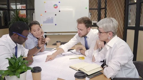 American multiethnic team looking of startup project, work at desk in lighting Stock Footage 98293819