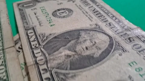 American one dollar bills moving in motion on green table background Stock Footage 339499071