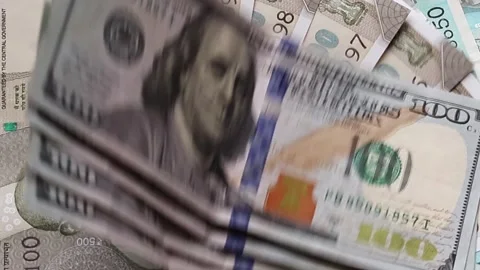 American one hundred dollar banknotes are placed on top of Indian rupees Stock Footage 302582177
