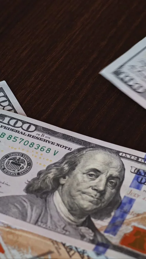 American one hundred dollar banknotes fall on the table surface Stock Footage 332209132