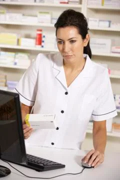 American pharmacist using computer in pharmacy Stock Photos