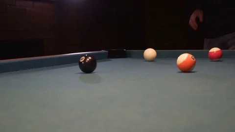 American Pool, young man is aiming to hit the eight ball Stock Footage 83098756