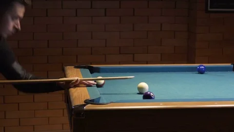American Pool, young man is aiming to hit the cue ball Video stock 83656785