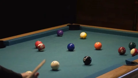 American Pool, young man is aiming to hit the ball in the pocket Stock Footage 83665133