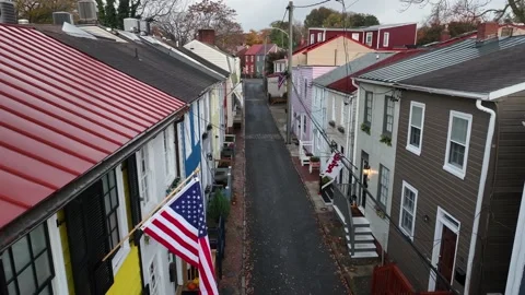 American pride flags in historic colonial home area. Aerial view of quaint Stock Footage 221423601