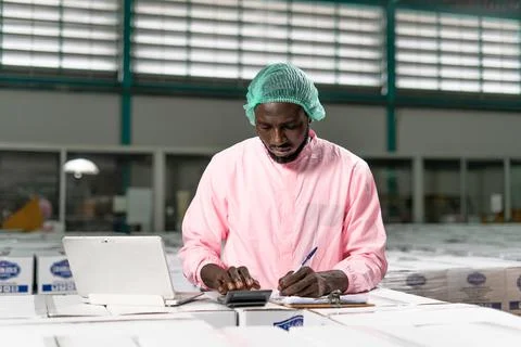 American raw material inspector work with computer to take note inspect data  Stock Photos