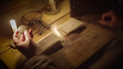 American Revolution | Examining a Colonial coin by candlelight (2) Stock Footage