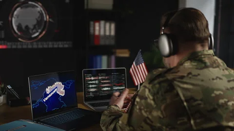 American service member in headset coordinating military mission in Venezuela Stock Footage 334670498