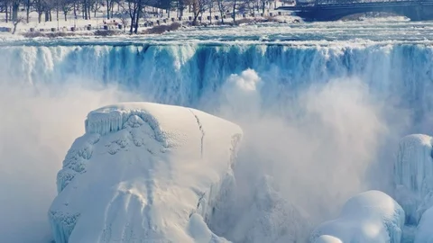 American side of Niagara Falls in winter. Water falls on blocks of ice and snow Stock Footage 94668766