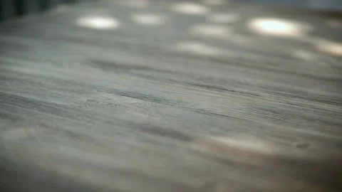 American silver coins falling in slow motion onto a wooden, rotating as they Stock Footage 136745949
