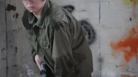 American soldier breaking out a window with his rifle then firing  Stock Footage 79973025