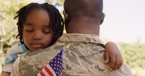 American soldier is hugging his son Stock Footage
