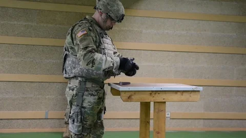 American soldier loading a gun during shooting training exercises Video stock 88143638