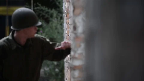 American soldier throws grenade out window then seeks cover Stock Footage 79972906
