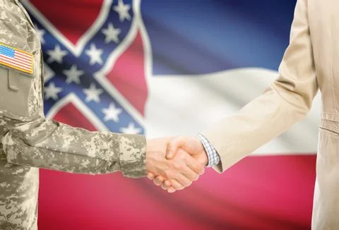 American soldier in uniform and civil man in suit shaking hands with USA stat Stock Photos