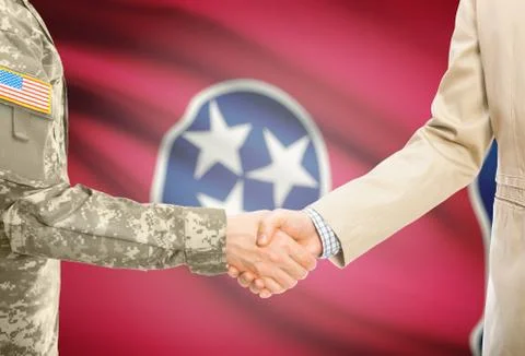 American soldier in uniform and civil man in suit shaking hands with USA stat Фото
