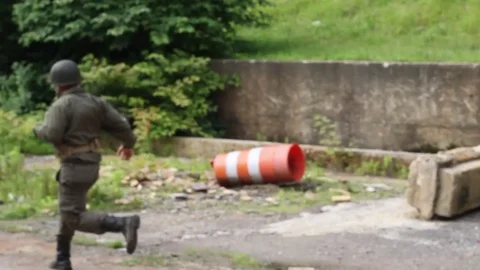 American soldiers evacuating an enemy infested building Stock Footage 79972756