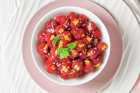 American summer raspberry rocket on a pink plate Stock Photos
