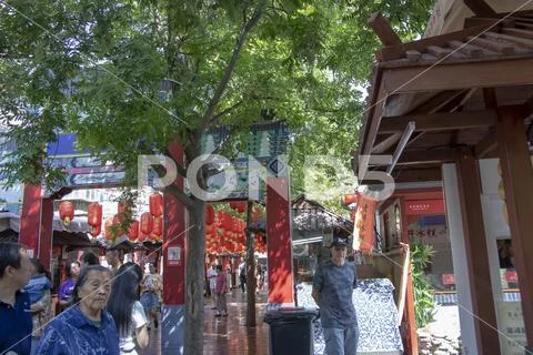 American tourists on crowded streets at Yongxingfang Intangible Cultural Heri Stock Photos