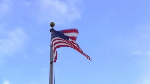 American USA Flag blowing in the Wind on a flagpole Stock Footage