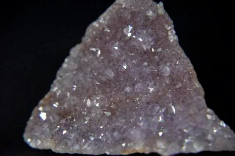 Amethyst crystals on the dark background with the side light. Stock Photos