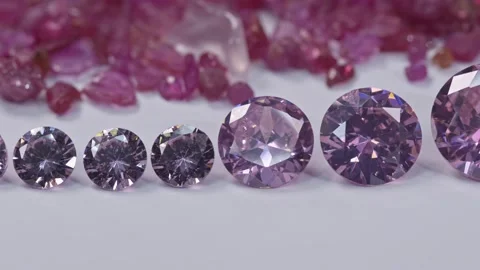 Amethyst diamonds in a row on white flore raw ruby gemstone background. Stock Footage 168481670