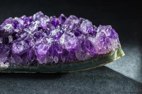 Amethyst druse crystal gemstone in geode on black Stock Photos