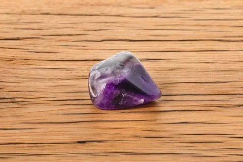 Amethyst on oak surface Stock Photos