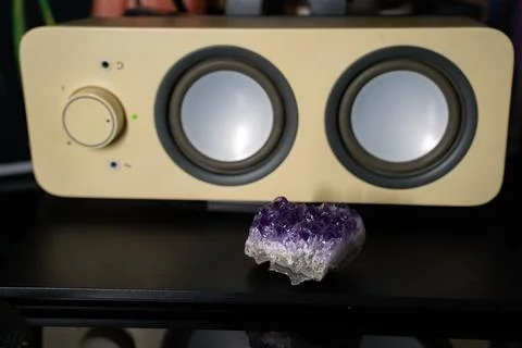 Amethyste geode on table in front of white speaker Stock Photos