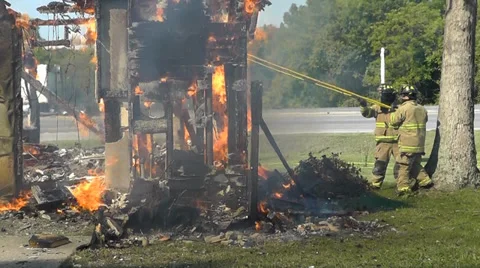 Amid the Force of Nature - House fire wall pushed by firemen Video stock 34632497