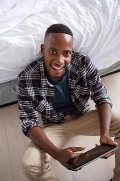 Amiling young man with tablet Stock Photos