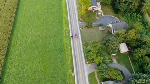 Amish buggy on busy country road, cars pass by, descending aerial drone 스톡 동영상 117581312