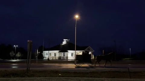 Amish in horse dran buggy early Stock Video Pond5