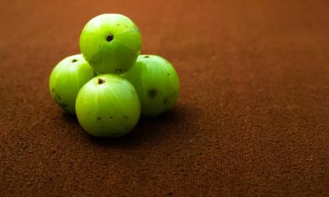 Amla on a brown background Stock Photos