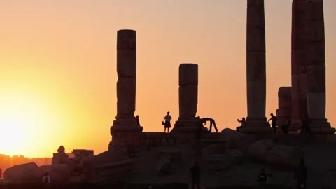 Amman citadel columns at sunset with visitor silhouettes ancient ruins oran.. Stock Footage 341271526