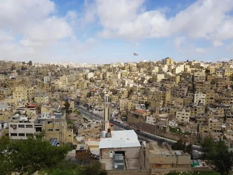 Amman’s white buildings and the Jordanian flag Stock Photos