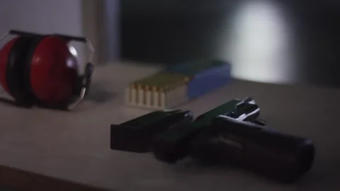 Ammunition Box and Two Pistols on Bench, Indoor Shooting Range, Close Up Shot Video stock 341321236