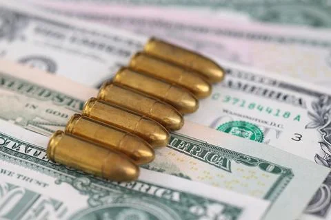 Ammunition Bullets on US Dollar Banknotes Stock Photos