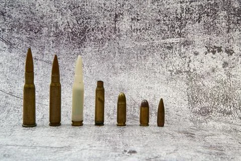 Ammunition for different weapons arranged in a row. Stock Photos