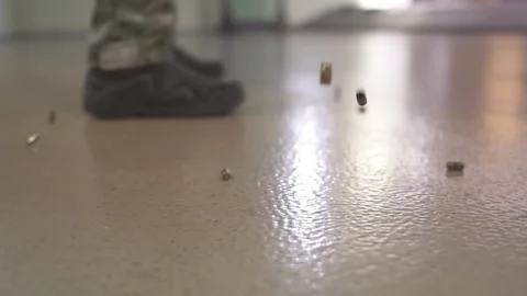 Ammunition falls to the floor. Fired shell casings from a machine gun. Stock Footage 239359050