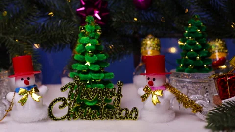 Among the Christmas tree branches there are snowmen with gifts and letters Stock Footage 323435870
