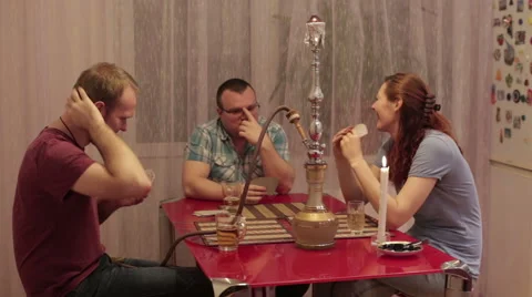 Among friends smoking shisha and playing cards Video stock 59583424