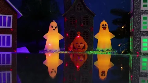 Among the houses is a gray one surrounded by glowing ghost figures Stock Footage 346601667