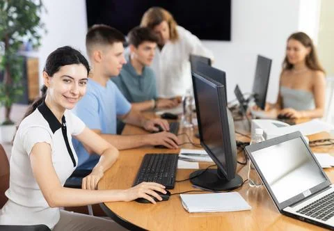 Among students of computer academy programmers, young girl is sitting and Stock-Fotos