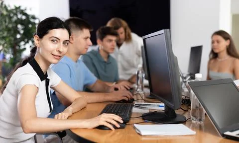 Among students of computer academy programmers, young girl is sitting and Stock-Fotos