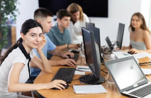 Among students of computer academy programmers, young girl is sitting and Stock-Fotos