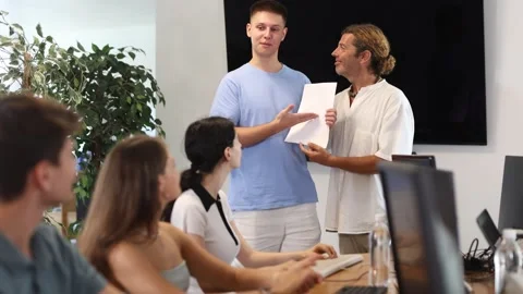 Among students of computer courses, male teacher awards diploma and to excellent Stock Footage 317134262