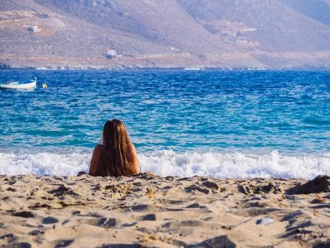 Amorgos, Greece-August 2,2017.A girl enjoying the sun and the sea on the beac Stock Photos